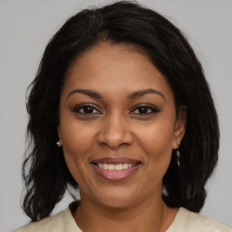 Joyful black young-adult female with medium  brown hair and brown eyes