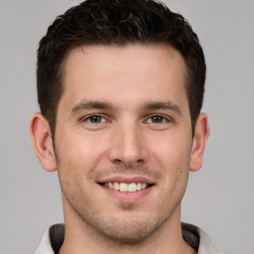 Joyful white young-adult male with short  brown hair and brown eyes