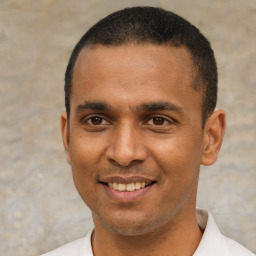 Joyful latino young-adult male with short  black hair and brown eyes