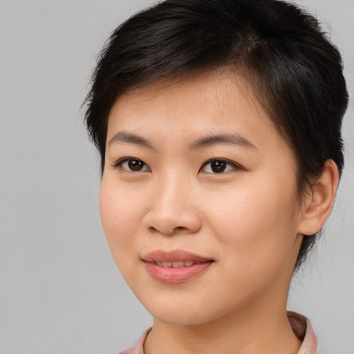 Joyful asian young-adult female with short  brown hair and brown eyes