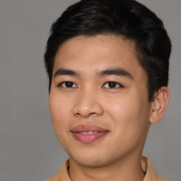 Joyful asian young-adult male with short  brown hair and brown eyes