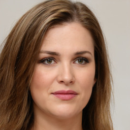 Joyful white young-adult female with long  brown hair and green eyes