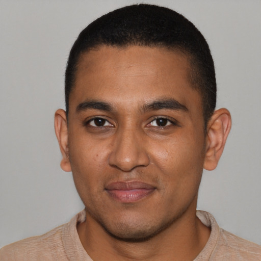 Joyful black young-adult male with short  brown hair and brown eyes