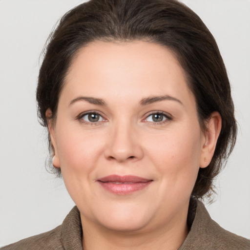 Joyful white adult female with medium  brown hair and brown eyes