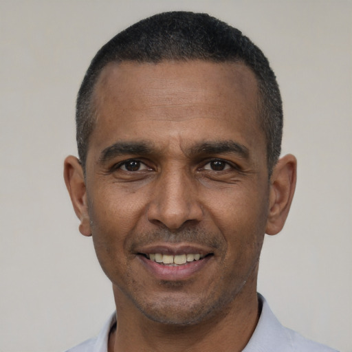 Joyful latino adult male with short  black hair and brown eyes