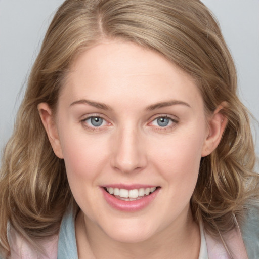 Joyful white young-adult female with medium  brown hair and blue eyes