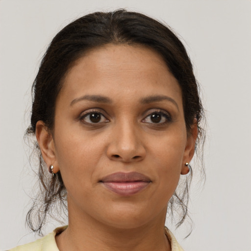 Joyful black young-adult female with medium  brown hair and brown eyes