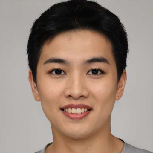 Joyful asian young-adult male with short  black hair and brown eyes