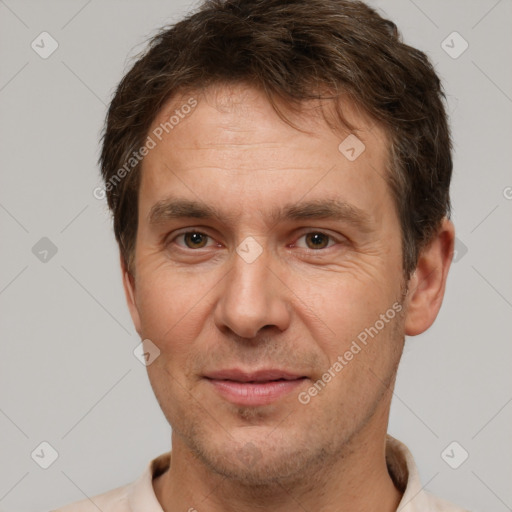 Joyful white adult male with short  brown hair and brown eyes