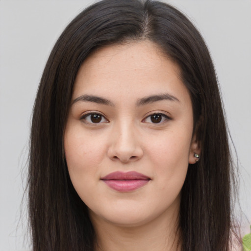 Joyful asian young-adult female with long  brown hair and brown eyes