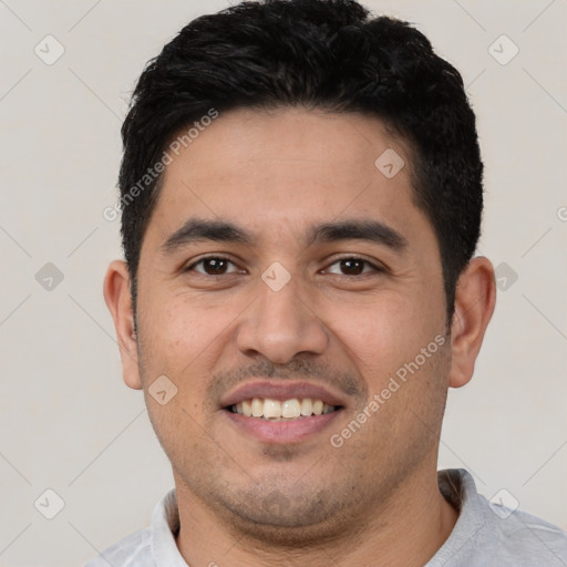 Joyful white young-adult male with short  black hair and brown eyes