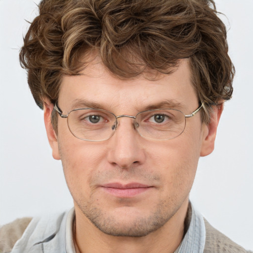 Joyful white adult male with short  brown hair and grey eyes