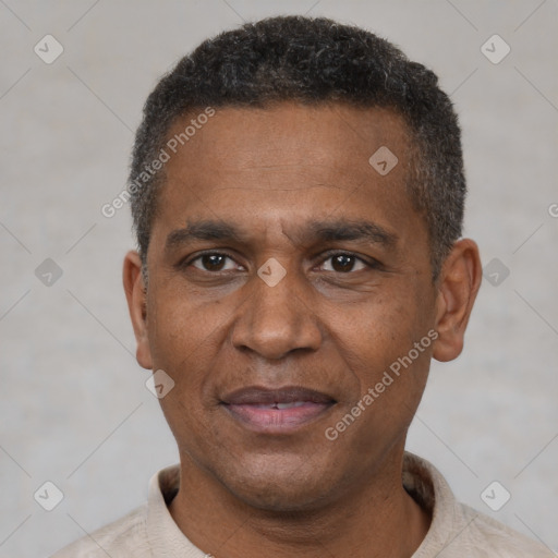 Joyful black adult male with short  black hair and brown eyes