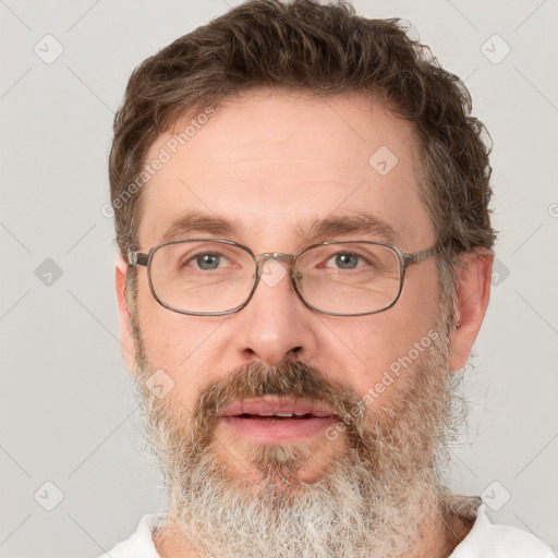 Joyful white adult male with short  brown hair and grey eyes