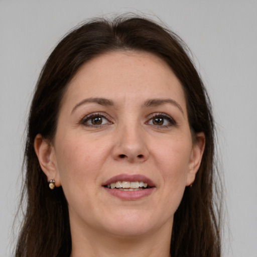 Joyful white adult female with long  brown hair and grey eyes