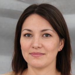 Joyful white adult female with medium  brown hair and brown eyes