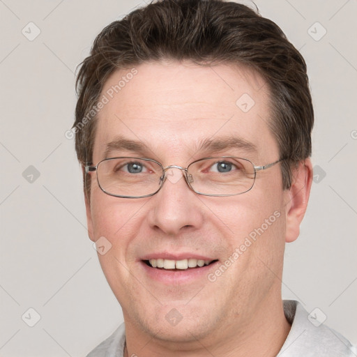 Joyful white adult male with short  brown hair and grey eyes