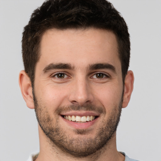 Joyful white young-adult male with short  brown hair and brown eyes