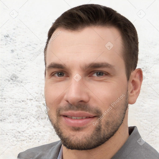 Joyful white young-adult male with short  brown hair and brown eyes