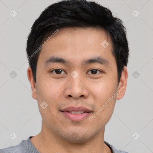 Joyful asian young-adult male with short  black hair and brown eyes