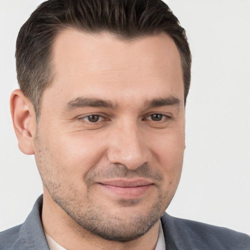 Joyful white adult male with short  brown hair and brown eyes