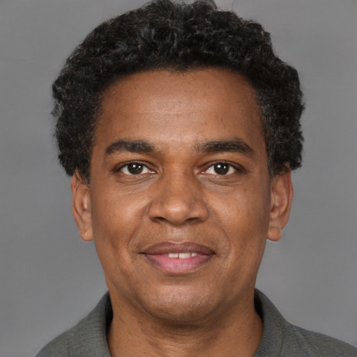 Joyful latino adult male with short  black hair and brown eyes