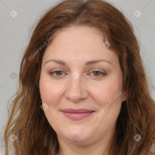 Joyful white adult female with long  brown hair and brown eyes