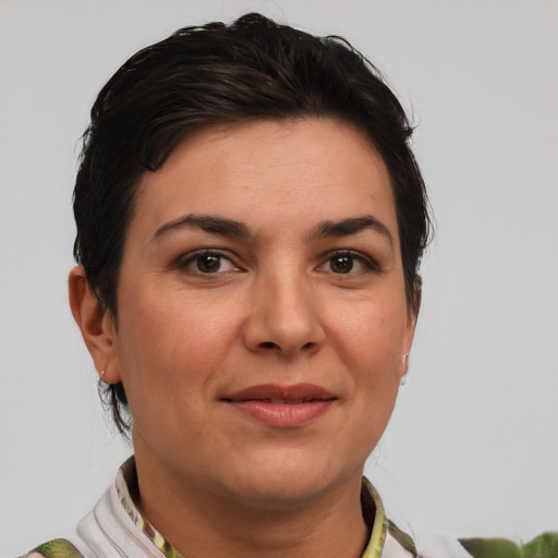 Joyful white young-adult female with short  brown hair and green eyes