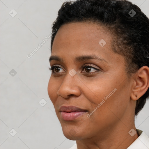 Joyful black young-adult female with short  brown hair and brown eyes