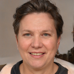 Joyful white adult female with medium  brown hair and grey eyes