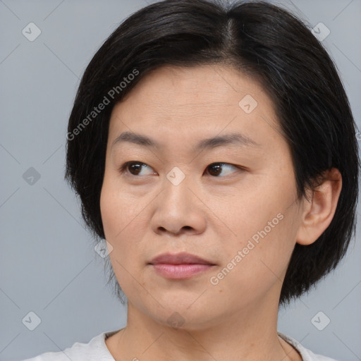 Joyful asian young-adult female with medium  black hair and brown eyes