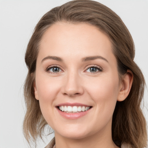 Joyful white young-adult female with long  brown hair and grey eyes