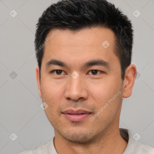 Joyful asian young-adult male with short  black hair and brown eyes