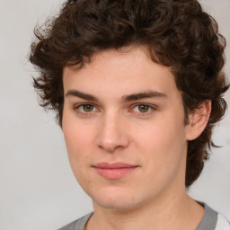 Joyful white young-adult male with medium  brown hair and brown eyes