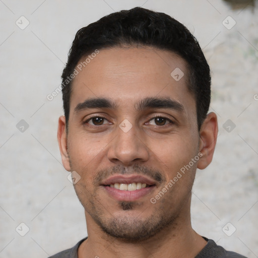 Joyful white young-adult male with short  black hair and brown eyes