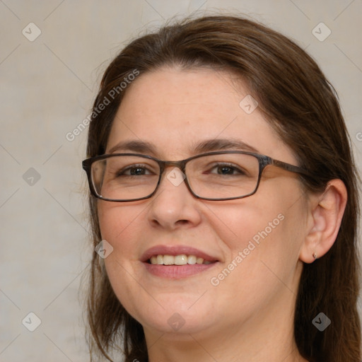 Joyful white adult female with medium  brown hair and blue eyes