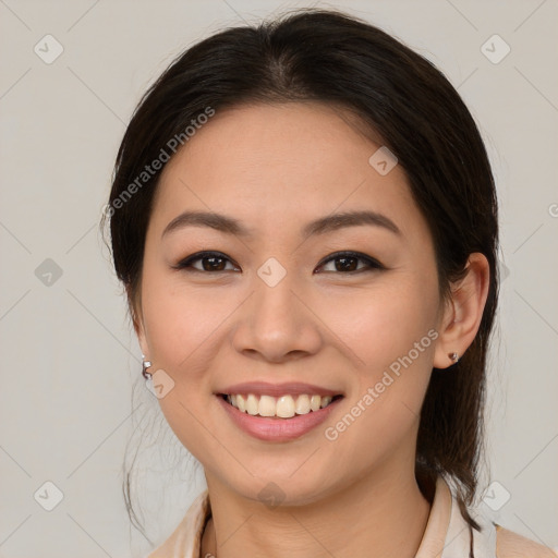 Joyful latino young-adult female with medium  brown hair and brown eyes