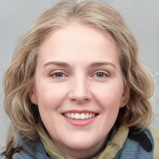 Joyful white young-adult female with medium  brown hair and blue eyes