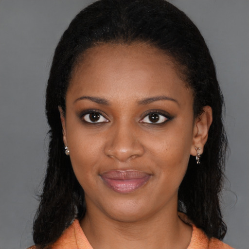 Joyful black young-adult female with long  brown hair and brown eyes