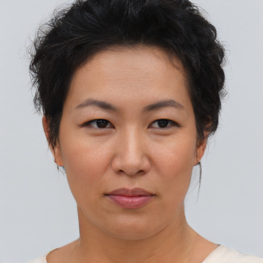 Joyful asian young-adult female with short  brown hair and brown eyes