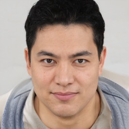 Joyful asian young-adult male with short  brown hair and brown eyes