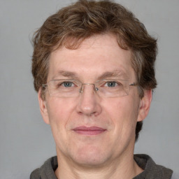 Joyful white middle-aged male with short  brown hair and blue eyes