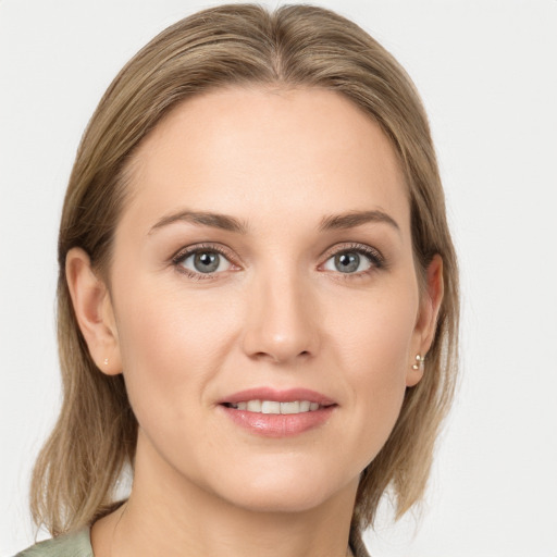 Joyful white young-adult female with medium  brown hair and grey eyes