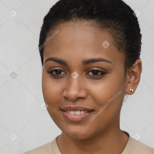 Joyful black young-adult female with short  brown hair and brown eyes