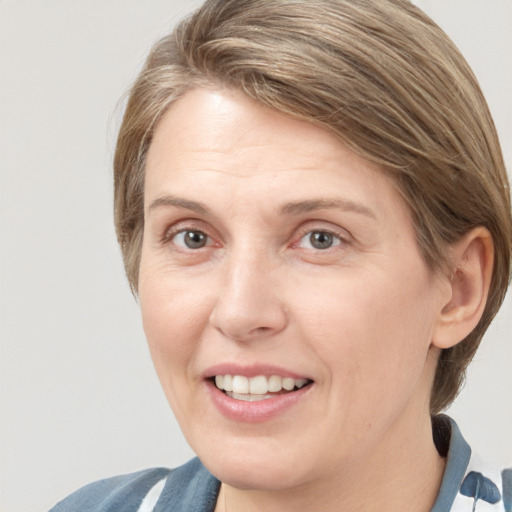 Joyful white adult female with medium  brown hair and grey eyes