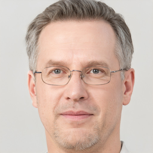 Joyful white adult male with short  brown hair and grey eyes