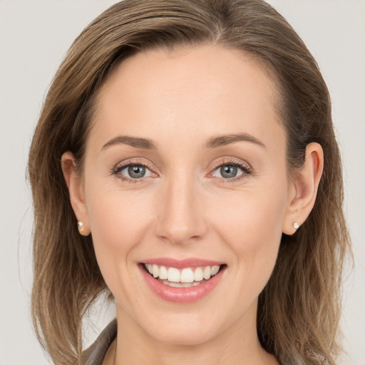 Joyful white young-adult female with long  brown hair and grey eyes