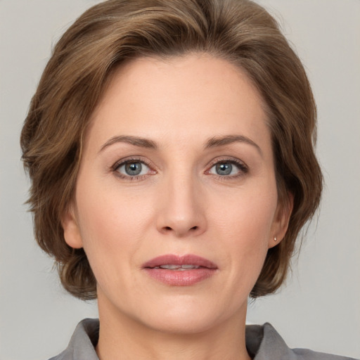 Joyful white adult female with medium  brown hair and grey eyes