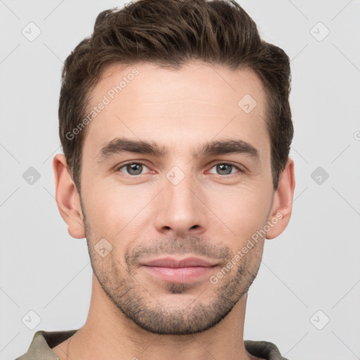 Joyful white young-adult male with short  brown hair and grey eyes