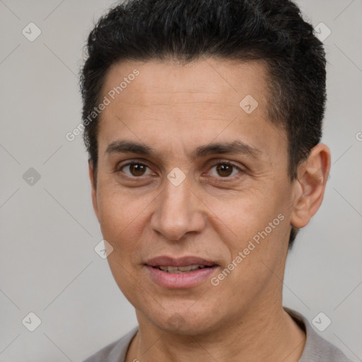 Joyful white adult male with short  black hair and brown eyes